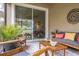 Relaxing screened patio with comfy seating and wood furniture at 1815 Sunset Wind Loop # 118, Oldsmar, FL 34677