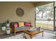 Cozy screened patio featuring a sofa and a coffee table at 1815 Sunset Wind Loop # 118, Oldsmar, FL 34677