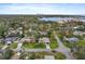 Aerial view of the home featuring mature trees and lush landscaping near a body of water and the city at 200 57Th S Ave, St Petersburg, FL 33705