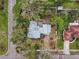 An aerial shot showcases the property's layout and surrounding lush landscaping providing privacy and a serene atmosphere at 200 57Th S Ave, St Petersburg, FL 33705