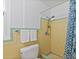 Retro bathroom with yellow tile, shower, and updated toilet at 200 57Th S Ave, St Petersburg, FL 33705
