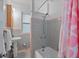 Gray tiled bathroom with updated shower and tub at 200 57Th S Ave, St Petersburg, FL 33705