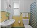 Retro bathroom with yellow tile, shower/tub combo, and updated toilet at 200 57Th S Ave, St Petersburg, FL 33705