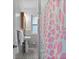 Clean bathroom with gray tile and pink accents at 200 57Th S Ave, St Petersburg, FL 33705