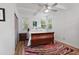Main bedroom with full-size bed, nightstand, and colorful rug at 200 57Th S Ave, St Petersburg, FL 33705