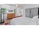 Main bedroom with dresser, full-size bed, and access to the bathroom at 200 57Th S Ave, St Petersburg, FL 33705