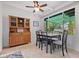 Charming dining area features a wood hutch and table with four chairs, bathed in natural light at 200 57Th S Ave, St Petersburg, FL 33705