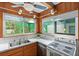 Bright kitchen boasts wood cabinets, stainless steel appliances, and a view of the backyard at 200 57Th S Ave, St Petersburg, FL 33705