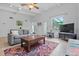 Living room with hardwood floors, comfortable seating, and a TV at 200 57Th S Ave, St Petersburg, FL 33705
