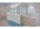 Bathroom features a large vanity, shower, and garden tub at 2342 Edelweiss Loop, Trinity, FL 34655