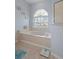 Bathroom with garden tub and large window at 2342 Edelweiss Loop, Trinity, FL 34655