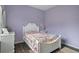 Charming bedroom with white bed frame, floral bedding, and a ceiling fan at 2342 Edelweiss Loop, Trinity, FL 34655