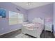 Charming bedroom with a white bed frame, floral bedding, and a ceiling fan at 2342 Edelweiss Loop, Trinity, FL 34655