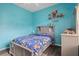 Cozy bedroom with gray bed frame, colorful bedding, and ample storage at 2342 Edelweiss Loop, Trinity, FL 34655