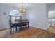 Elegant dining room with hardwood floors and a chandelier at 2342 Edelweiss Loop, Trinity, FL 34655