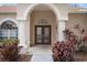 Double front doors with arched entryway and decorative glass at 2342 Edelweiss Loop, Trinity, FL 34655
