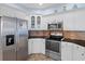 Modern kitchen with stainless steel appliances and granite countertops at 2342 Edelweiss Loop, Trinity, FL 34655