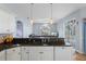 Modern kitchen with island, seating and view of pool at 2342 Edelweiss Loop, Trinity, FL 34655