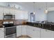 Modern kitchen with stainless steel appliances and granite countertops at 2342 Edelweiss Loop, Trinity, FL 34655