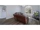 Spacious living room with leather furniture and large window at 2342 Edelweiss Loop, Trinity, FL 34655