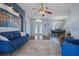 Living area with blue sofa, hardwood floors, and a view of the entry at 2342 Edelweiss Loop, Trinity, FL 34655