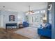 Living room with hardwood floors, blue sofa, and access to backyard at 2342 Edelweiss Loop, Trinity, FL 34655