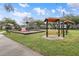 Community playground with playsets and shaded seating at 2342 Edelweiss Loop, Trinity, FL 34655