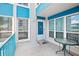 Private balcony with a glass table and chairs, offering a view of the street at 343 Rex Pl # F, Madeira Beach, FL 33708