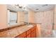 Bathroom with granite vanity, shower, and washer/dryer at 343 Rex Pl # F, Madeira Beach, FL 33708