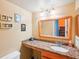 Bathroom with granite vanity and large mirror at 343 Rex Pl # F, Madeira Beach, FL 33708