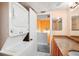 Bright bathroom boasts a granite vanity and stackable washer/dryer at 343 Rex Pl # F, Madeira Beach, FL 33708
