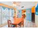 Bright dining area with wood table and kitchen view at 343 Rex Pl # F, Madeira Beach, FL 33708