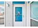 White condo door featuring a parrot design, welcoming guests to the unit at 343 Rex Pl # F, Madeira Beach, FL 33708