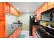 Galley kitchen with granite counters and appliances at 343 Rex Pl # F, Madeira Beach, FL 33708