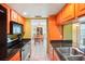 Kitchen with granite counters, wood cabinets, and view of dining area at 343 Rex Pl # F, Madeira Beach, FL 33708