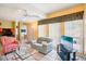 Bright living room with a flat-screen TV, couches, and a view of the balcony at 343 Rex Pl # F, Madeira Beach, FL 33708
