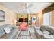 Bright living room with comfy seating and view of kitchen at 343 Rex Pl # F, Madeira Beach, FL 33708