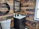 Bathroom boasts wood-like wall accents and modern vanity at 34421 Countryside Dr, Wesley Chapel, FL 33543