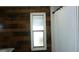 Clean bathroom with wood-look walls and a shower/tub combo at 34421 Countryside Dr, Wesley Chapel, FL 33543