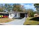 Mobile home with carport and well-maintained lawn at 34421 Countryside Dr, Wesley Chapel, FL 33543