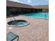 Community pool and spa with brick patio at 34421 Countryside Dr, Wesley Chapel, FL 33543