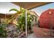Side yard with red shed, plants, and a covered patio area at 4506 24Th S Ave, Tampa, FL 33619
