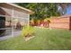 Private backyard with a screened patio and lush green grass at 5301 Watson Rd, Riverview, FL 33578