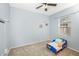 Bedroom with carpet, ceiling fan, and a toddler bed at 5301 Watson Rd, Riverview, FL 33578