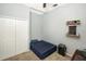 Cozy bedroom with a double bed, closet, and built-in shelving at 5301 Watson Rd, Riverview, FL 33578