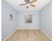 Well-lit bedroom with hardwood floors and ceiling fan at 5301 Watson Rd, Riverview, FL 33578