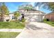 Cute one-story house with a two-car garage and well-manicured lawn at 5301 Watson Rd, Riverview, FL 33578