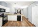 Modern kitchen featuring white cabinets, granite countertops, and black appliances at 5301 Watson Rd, Riverview, FL 33578