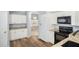 Kitchen with white cabinets, granite countertops, and black appliances at 5301 Watson Rd, Riverview, FL 33578
