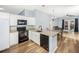 Modern kitchen with granite countertops, white cabinets, and black appliances at 5301 Watson Rd, Riverview, FL 33578